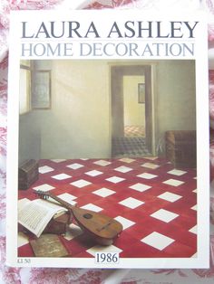 a book with an image of a violin on the floor in front of a red and white checkered tablecloth