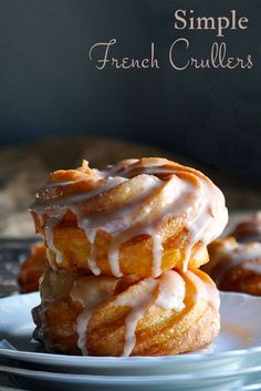 three glazed donuts stacked on top of each other with icing drizzled over them