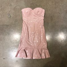 a pink dress is laying on the floor