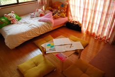 a bedroom with stuffed animals on the bed