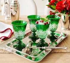 green glass cups and glasses on a tray