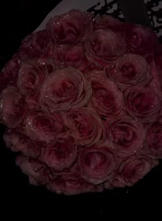 a bouquet of pink roses sitting on top of a table