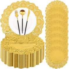 a set of gold tableware with lace doily