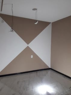 an empty room with white and brown walls