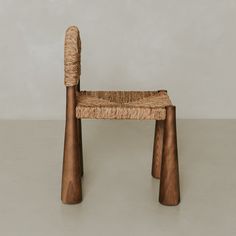 a chair made out of wood and woven material with two wooden sticks sticking out of the seat