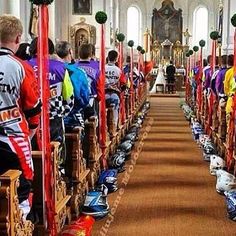 many people are sitting in pews with helmets on them