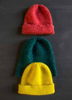 two knitted hats sitting next to each other