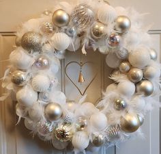 a wreath with white and silver ornaments on it