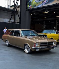 an old station wagon parked in front of a building