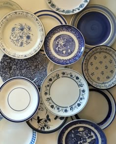 many blue and white plates are stacked on top of each other in the same pattern