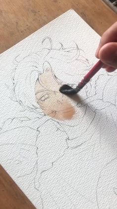 someone is drawing on paper with a pencil