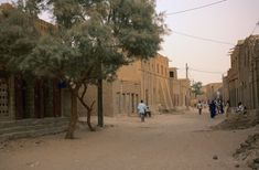 people are walking down the street in an old town with no cars or trucks on it