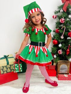 Your sweet elf will sparkle with joy in our sequin tutu dress. Dressing your merry munchkin in her holiday best has never been quite as fun as this. It's the most fashionable time of the year! Keeps its cuteness wash after wash Buttery-soft fabric for all-day comfort Perfect her Holiday party, formal event, pageant, pretend play, or pictures wardrobe Puff-sleeve elf tutu dress with pom-pom applique collar, sequin mesh bodice, velvet belt, striped fabric with pom-pom tassels, and a gathered tulle Elf Outfit Kids, Elf Costume Girl, Christmas Pageant Wear, Christmas Outfit For Kids, Kids Christmas Dress, Christmas Dress Up, Velvet Belt, Toddler Flower Girls, Set Dressing