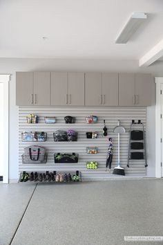 a garage filled with lots of storage and hanging utensils on the wall next to it