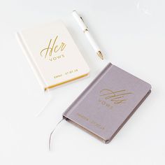 a note book and pen sitting next to each other on a white surface with gold lettering