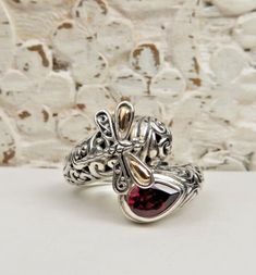 GORGEOUS GARNET AND STERLING SILVER 18K GOLD DRAGONFLY RING ....... ......Size 7 .....Face of ring is 3/4" in width...Stone is 3/8" in length... In great condition! Nice teardrop garnet with a deep red/purple color. Ring also features a dragonfly with 18K gold accents. Very nice sterling silver metalwork and design! Marked 925 and 18K. Dragonfly Ring, Ring Pictures, Color Ring, Red Garnet, Ring Size 7, Red Purple, Deep Red, Gold Accents, Purple Color