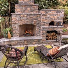 an outdoor fireplace with chairs around it