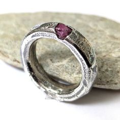 Raw ruby ring sandcast in sterling silver.  Size AU/UK N 1/2, US 7.25 Gorgeous solid silver domed band with organic texture left by the sand and flow of the molten silver. Treat yourself or gift to someone special. This ring makes a perfect engagement or anniversary gift. These rings are very durable making them great for everyday wear.  Unisex design. These rings are cast in sand as one solid piece with melted fine silver and sterling silver. The casting is made from an original design carved i Rubin Ring, Unique Wedding Band, Raw Ruby, Unique Wedding Bands, Ruby Ring, Natural Texture, Unique Wedding, Fine Silver