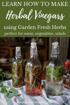 three bottles filled with herbs sitting on top of a table