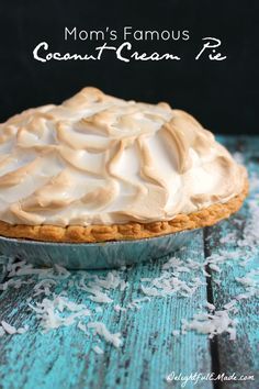 a pie sitting on top of a wooden table covered in frosting and icing