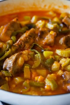 a white bowl filled with meat and vegetables