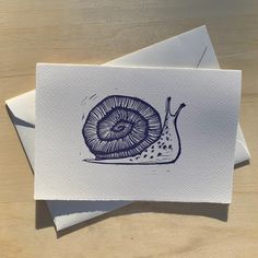 a card with a drawing of a snail on it