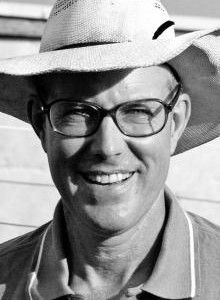 black and white photograph of a man wearing a hat