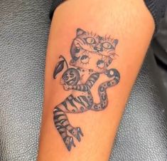 a person with a tiger tattoo on their leg