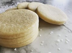 three cookies sitting on top of a table covered in white flecks next to each other