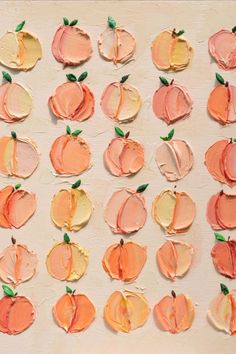 an art project with oranges and apples painted on it's side by side