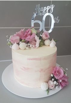 a white cake with pink flowers and the number 60 on top