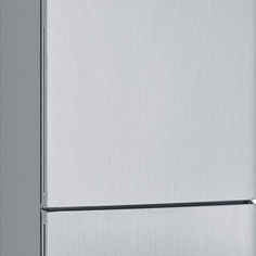 a silver refrigerator freezer sitting on top of a white counter next to a wall