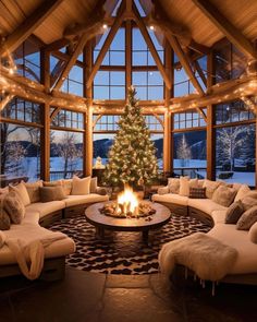 a living room filled with furniture and a christmas tree in the middle of the room