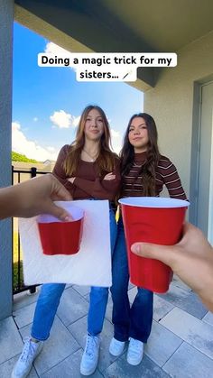 two girls standing on a porch holding up red cups with the caption doing a magic trick for my sisters