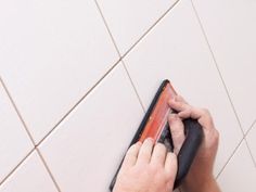 a person is cleaning the floor with a mop and cloth on top of it