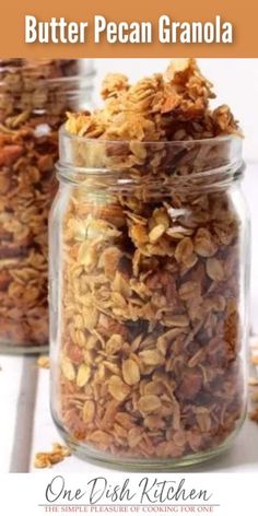 three jars filled with granola sitting on top of a table