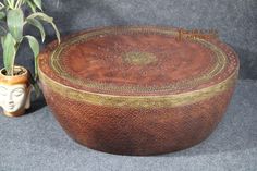 a decorative wooden box next to a potted plant