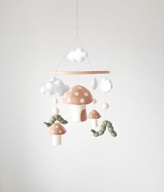 a mobile with mushrooms hanging from it's sides