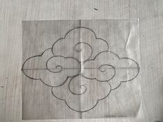 a piece of paper that has been cut into four clouds on top of each other