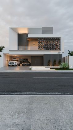 two cars are parked in front of a modern house