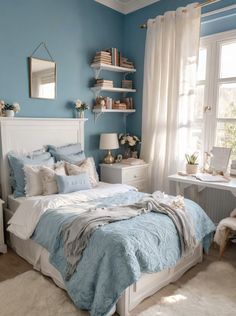 a bedroom with blue walls and white furniture