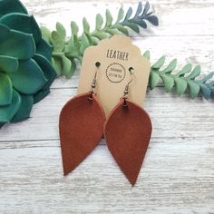 "These cinnamon brown suede pinched leaf petal leather earrings make a great statement, yet simple and easy for everyday wear.  They are super soft, lightweight and are sure to pair perfectly with any outfit!  They also make great gifts for moms, daughters, grandmothers, sisters, friends, teachers, coworkers, and more! *Size = Regular = 2.25\" long x 1.4\" wide with a drop length of 2.75\" *Thickness = 1.0mm = average* *last 2 photo show other shapes, sizes and styles in this collection* > Durable > Noise free > Affordable > Nickel free fishhook ear wire > Rubber backs included so you can wear them without losing one! I have a variety of colors and styles to choose from so be sure to view my other listings: https://bethwolfhandmade.etsy.com All items are made and ready to ship! ----------- Suede Earrings, Gifts For Moms, Cinnamon Brown, Great Gifts For Mom, Fun Earrings, Leather Earrings, Fish Hook, Ear Wire, Brown Suede