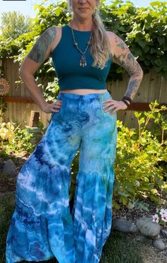 Made from 100% woven Rayon Light, these tiered pants have bohemian flare!   Comfortable and easy to wear with elastic waistband and two gathered tiers in the pant legs.  US Women's size small. measurements: waist: 14-21"(stretched) inseam: 32" rise: 14" hip: 23" Bohemian Spring Bottoms With Flared Hem, Bohemian Summer Festival Bottoms, Flowy Tiered Bottoms For Vacation, Flowy Ruffled Casual Bottoms, Casual Flowy Ruffled Bottoms, Casual Ruffled Flare Bottoms, Casual Flowy Bottoms With Ruffles, Casual Flare Bottoms With Ruffles, Hippie Style Flared Bottoms For Spring