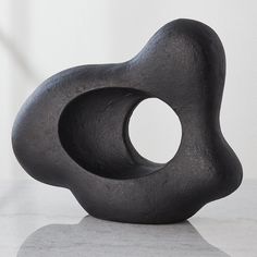 a black sculpture sitting on top of a white counter