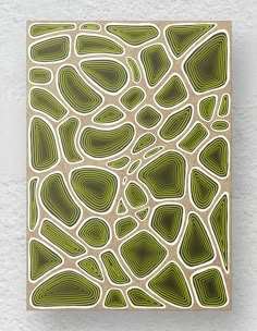 an abstract pattern in green and beige with white lines on the bottom half of it