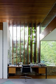 an office area with desk, chair and sliding glass doors that open up to the outside