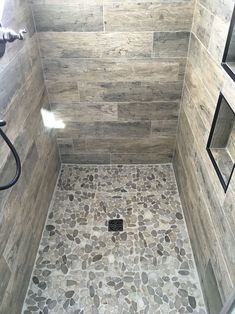 a walk in shower sitting next to a tiled floor