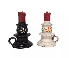 two black and white candlesticks sitting next to each other