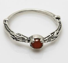 Dragon Serpent Power Ring - Enlightenment & Illumination. Features a natural authentic Carnelian gemstone. Handcrafted in Sterling Silver by Wellstone Jewelry in the USA. This ring is 1/16 of an inch in height. Symbolism and Meaning of the Dragon Serpent Power Ring: Since the dawn of humanity the dragon has appeared in the mythology of many cultures. It represents the darkness, the unknown, the power we hold but cannot yet wield. The dragon represents change, the necessity that we not only adapt to circumstance but that we ourselves become its active agent. It represents the passage from innocence through experience to wisdom and understanding. And ultimately the dragon is the symbol of the process of enlightenment, the channeling of the serpent power towards the great illumination. Dragon Serpent, Celtic Medieval, Serpent Dragon, Medieval Dragon, Mens Sterling Silver Necklace, Celtic Dragon, Silver Rings With Stones, Dragon Ring, Power Ring