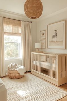 a baby's room with a crib, rug and pictures on the wall